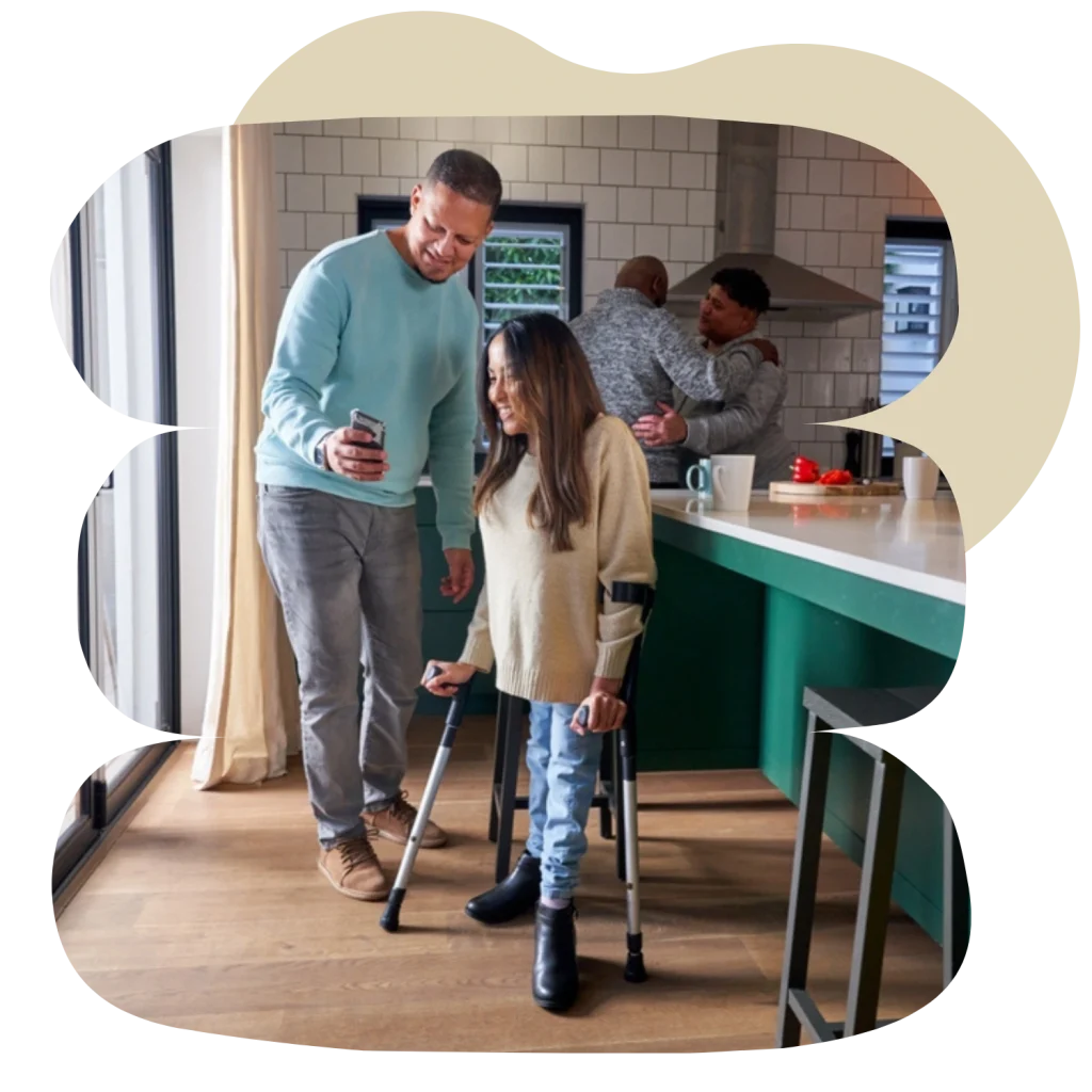 Disabled woman looking at phone with support worker