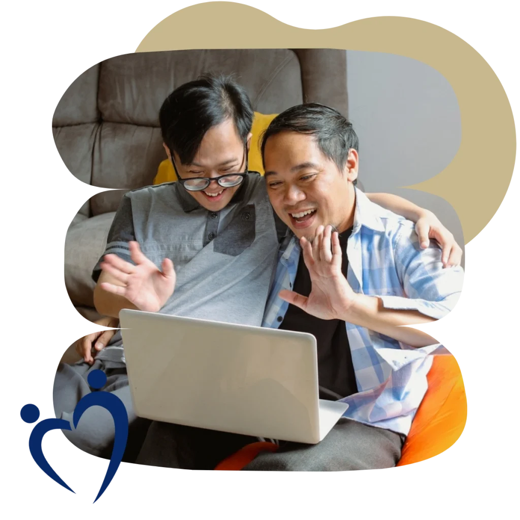 Disabled boy with father waving at laptop on video call