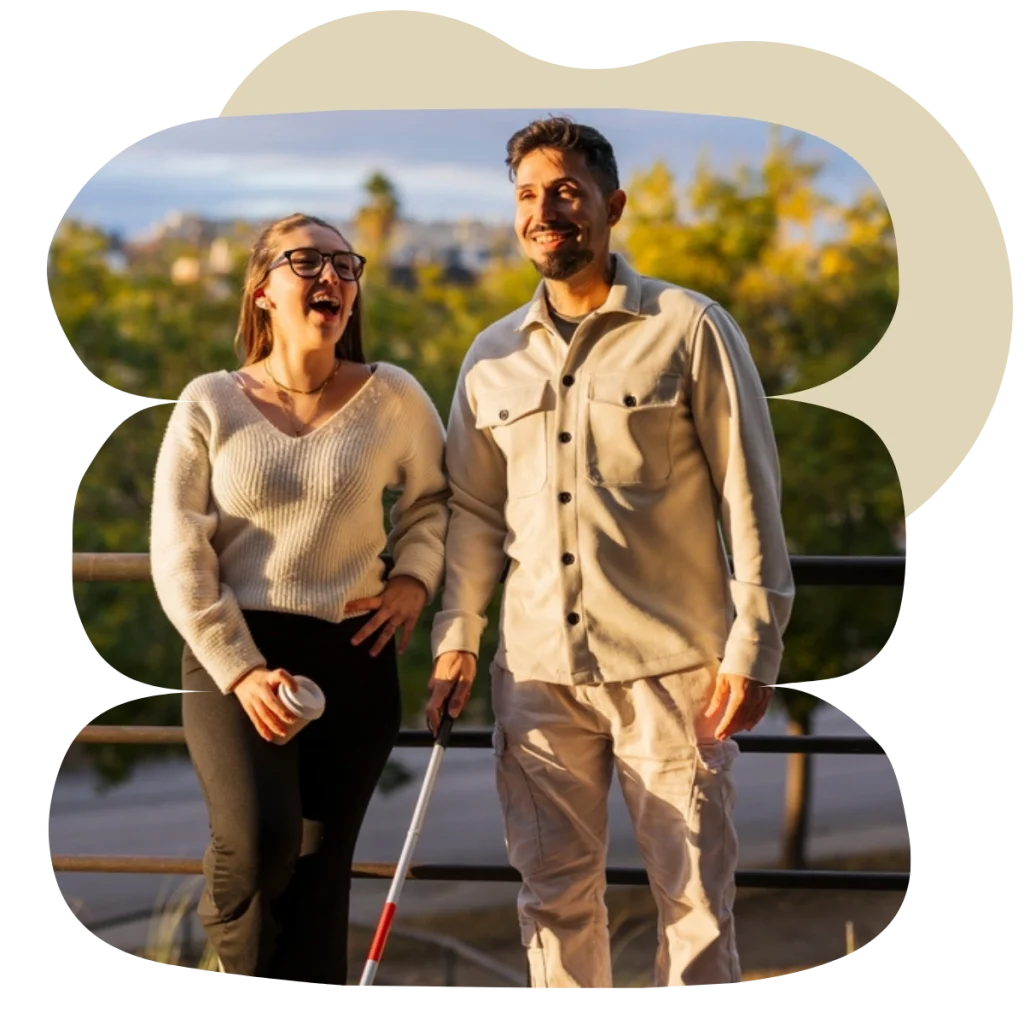 Blind man smiling with friend outside