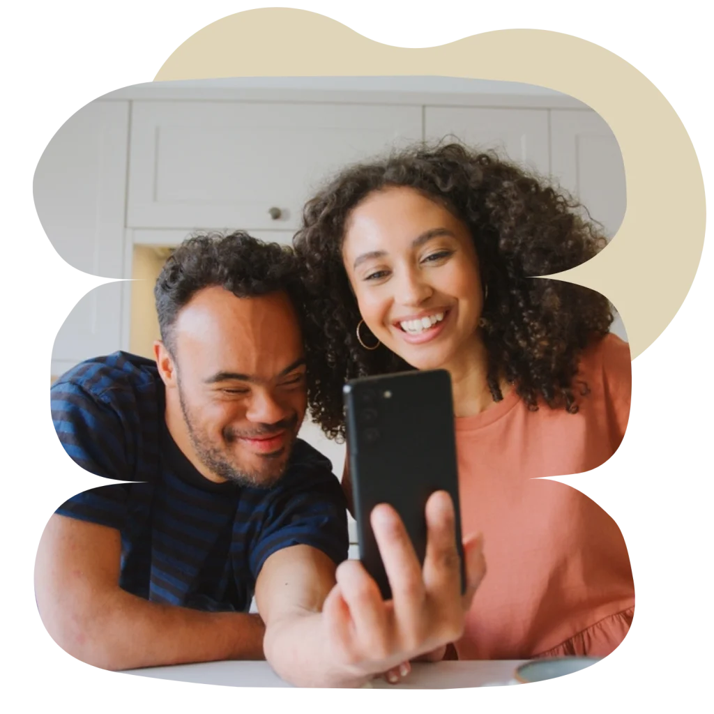 Disabled man and woman smiling on video call